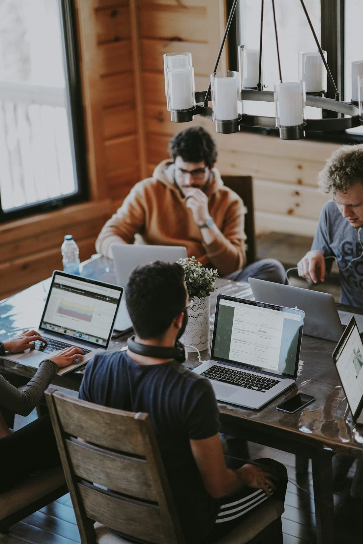 Professionals working together around a table in a bright, relaxed workspace